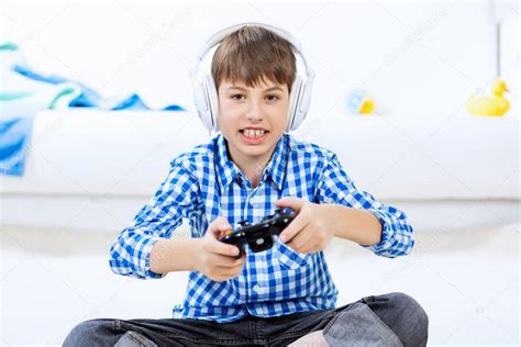 Boy Playing Game Console Stock Photo By ©sergeynivens 101644810