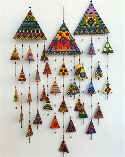 A Group Of Colorful Ornaments Hanging From The Side Of A Wall In Front