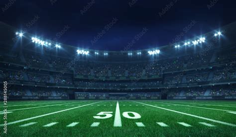 American football league stadium with white lines and fans, illuminated field side view at night ...