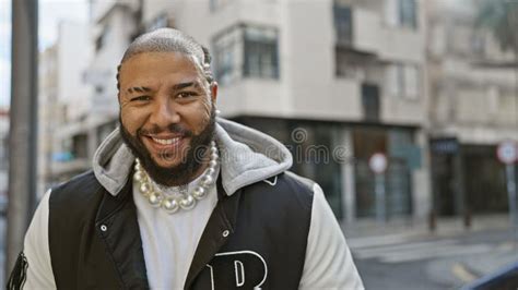 Cheerful Bearded African American Man Smiling In An Urban City Street