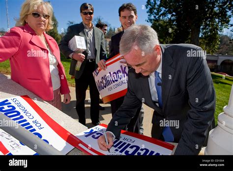 California Senator Tom McClintock signs yard signs after he announced ...