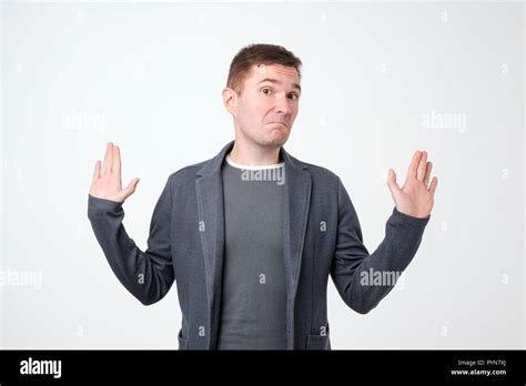 Doubtful Man With Thoughtful Expression Making Choice In Studio