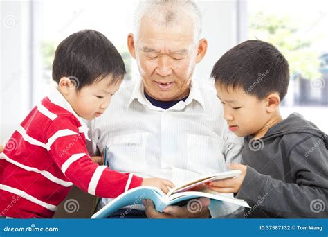 Grandfather And Grandchildren Reading A Book Stock Photo Image Of