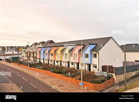 Row Of Affordable New Build Homes Finished Off In Different Pastle