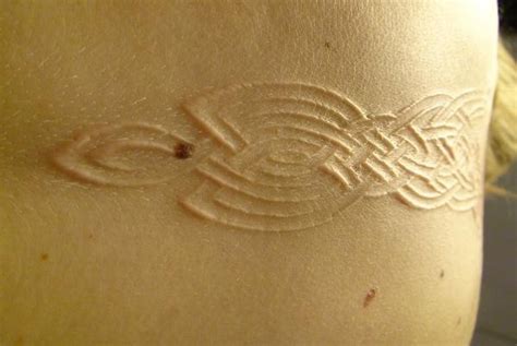 Pretty Scarification Tattoo Designs for Women - TattoosEra