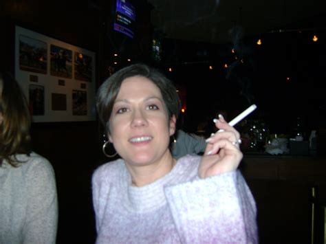 Mistress Gigi Smoking A Cigarette In A Bar Wearing Her Long Leather Gloves And Pants Mistress