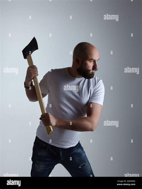 Man Of Caucasian Appearance Makes A Swing With An Axe Photo Shoot In