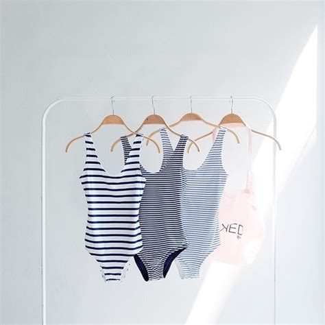 Three Baby Ones Hanging On A Clothes Rack