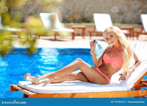 Beautiful Woman Bikini Model Tanned And Lying On Deck Chair Stock Photo