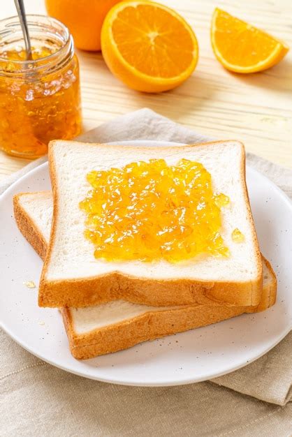 Premium Photo Slices Of Bread With Orange Jam