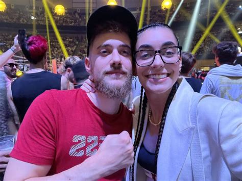 A Man And Woman Taking A Selfie At An Event