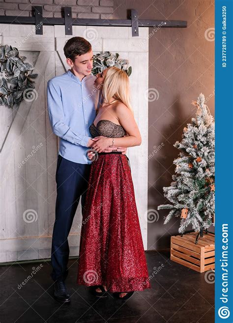 A Girl In A Beautiful Dress Hugs And Kisses A Guy New Yearand X27 S