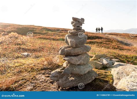 Stack Of Natural Irregular Stones In Grassland With People In Ba Stock