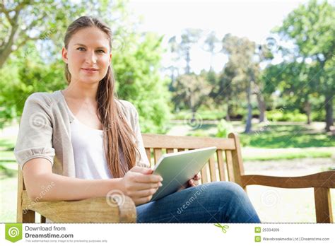 Femme S asseyant Sur Un Banc De Parc Avec Son Ordinateur De Comprimé