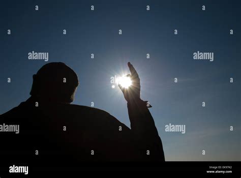 Man Holding A Sun In His Hands Against The Sky Stock Photo Alamy