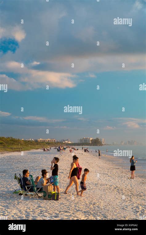 Family enjoying sunset on a winter's evening, Barefoot Beach, Naples, Florida, USA Stock Photo ...