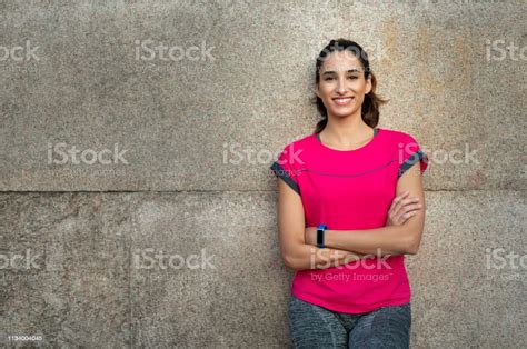 Sporty Woman Leaning Against Wall Stock Photo Download Image Now