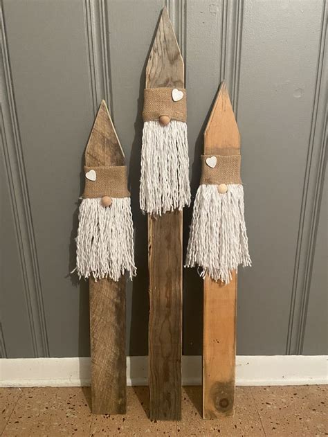 Two Wooden Sleds With White Tassels Are Standing Next To Each Other