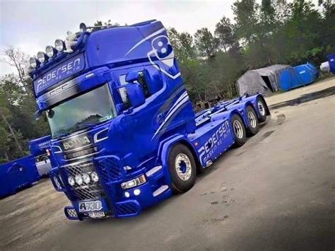 A Blue Semi Truck Parked In A Parking Lot