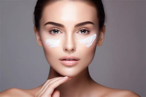 Premium AI Image Beautiful Woman Applying Moisturizer Cream On Her