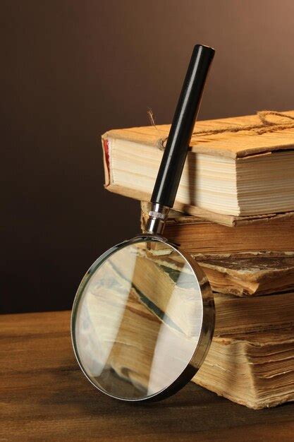 Premium Photo | Magnifying glass and books on table