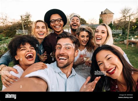 Friends Chilling Outside Taking Group Selfie And Smiling Laughing