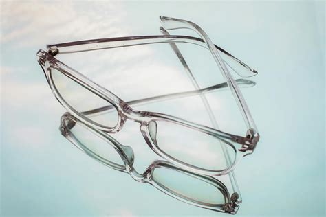 Eyeglasses in old fashioned frame on reflecting surface · Free Stock Photo