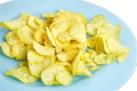 Premium Photo | Potato chips on blue plate. isolated on white