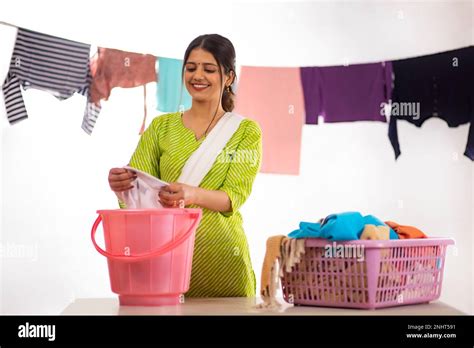 Happy young woman washing clothes by hand Stock Photo - Alamy