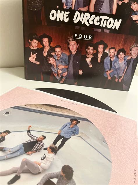 The One Direction Album Is Shown On A Table