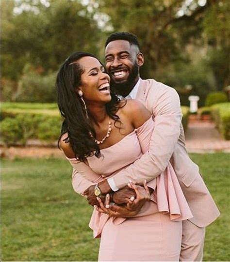 Black Couple Laughing As They Embrace Couples Engagement Photos