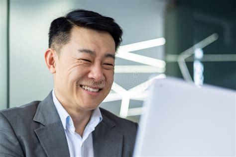 Closeup Of Cheerful And Successful Businessman Smiling And Looking At