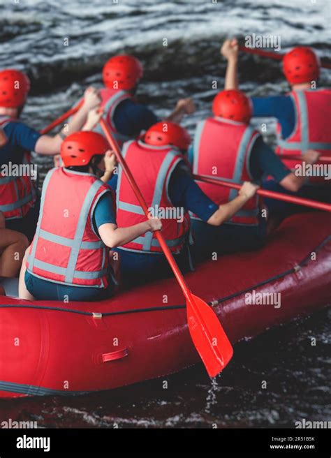 Red raft boat during whitewater rafting extreme water sports on water rapids, kayaking and ...