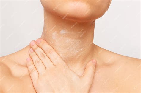 Premium Photo Cropped Shot Of A Young Woman Applying A Cream To Moisturize The Neck Skin On A