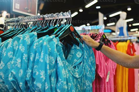 Woman selects a woman dress in a store 26388940 Stock Photo at Vecteezy