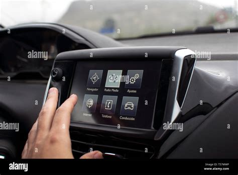 male hand touching screen in a modern car. A man driving a car. Car ...