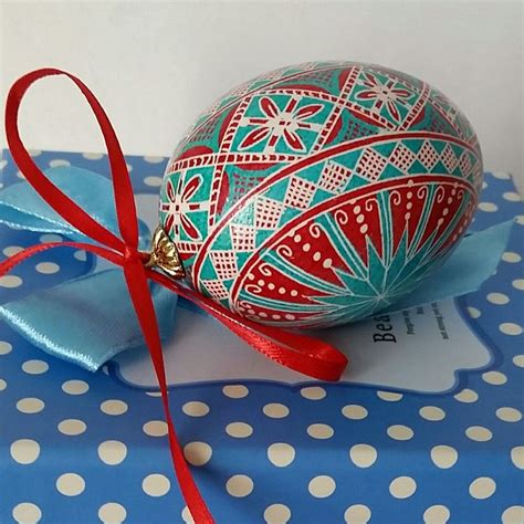 An Easter Egg Sitting On Top Of A Blue And White Polka Dot T Wrapper