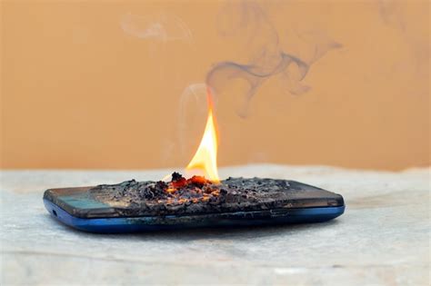 Premium Photo Mobile Phone In Fire And Smoke The Phone Caught Fire Due To Careless Handling