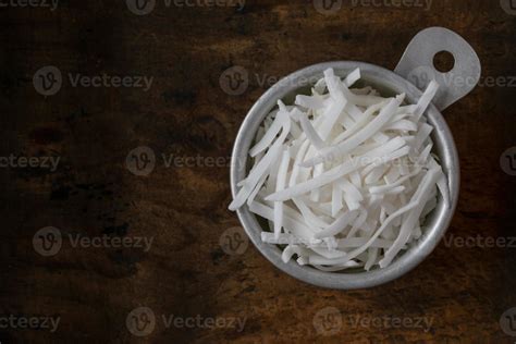 Unsweetened Coconut Flakes in a Measuring Cup 18882896 Stock Photo at Vecteezy