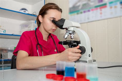 Beautiful Scientist Looking Under Microscope Female Scientist Using A