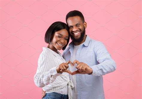 Loving Black Couple Making Heart With Their Hands Looking At Camera