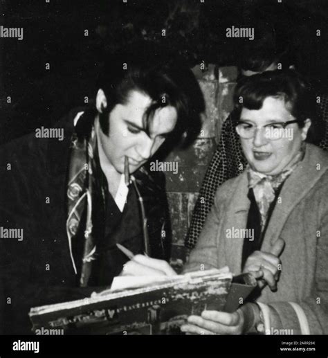 American Singer And Actor Elvis Presley Signing Autographs To Fans Usa