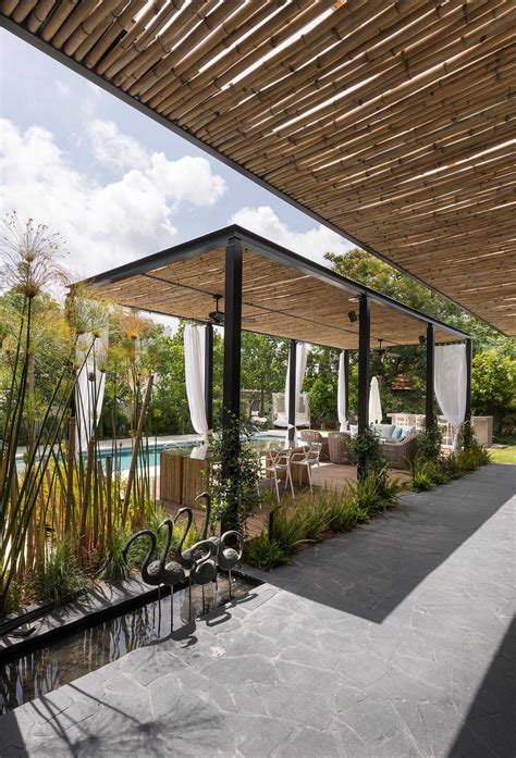 A Bamboo Pergola Creates Additional Outdoor Living Space At This Home