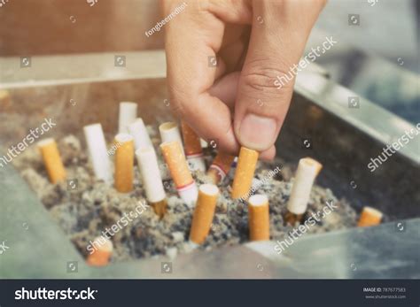 Hand Putting Out Butt On Cigarettes Stock Photo Edit Now