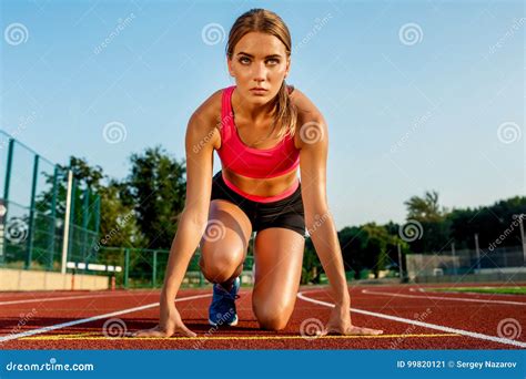 Young Woman Athlete At Starting Position Ready To Start A Race On