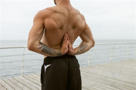 Premium Photo Muscular Man With Naked Torso Doing Yoga With Namaste