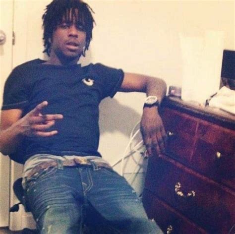 A Man Sitting On Top Of A Wooden Dresser