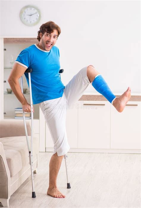 Leg Injured Young Man with Crutches at Home Stock Photo - Image of recovery, bandage: 332194654