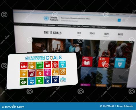 Person Holding Cellphone With Logo Of United Nations Sustainable Development Goals Sdg On