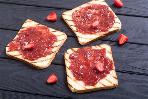 Toast with strawberry jam stock photo. Image of slice - 123768278